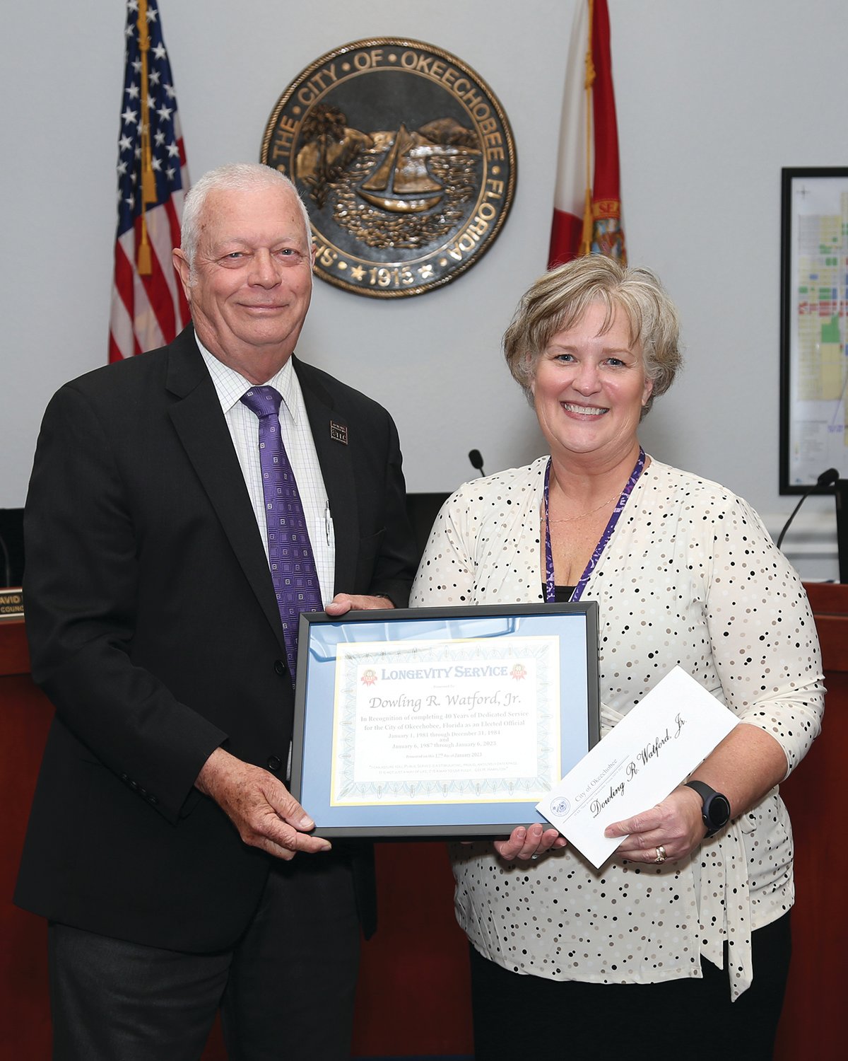 Mayor Dowling Watford is presented a certificate for 40 years of service to the city by City Clerk Lane Gamiotea.